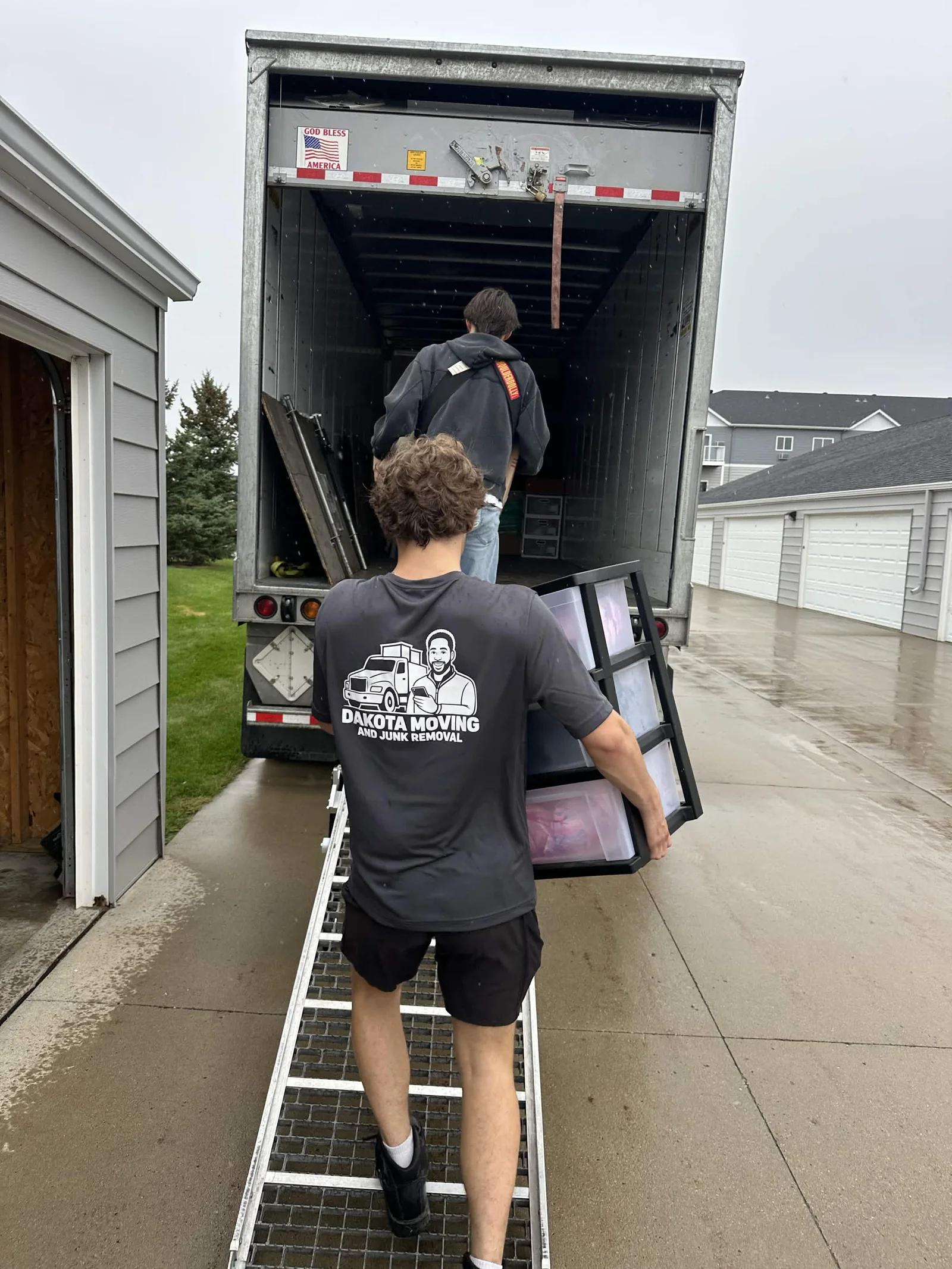 Dakota crew loading a moving truck up the ramp
